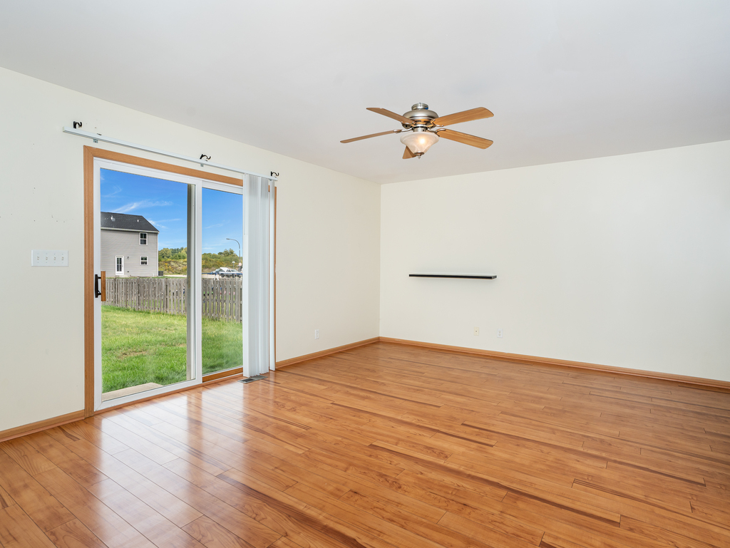 816 Kennedy Street Waterman, IL 60556 - Photo 6 of 27 a view of empty room with wooden floor and fan