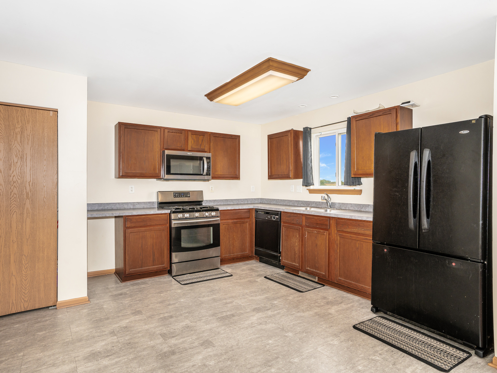 816 Kennedy Street Waterman, IL 60556 - Photo 8 of 27 a kitchen with stainless steel appliances granite countertop a refrigerator stove and oven
