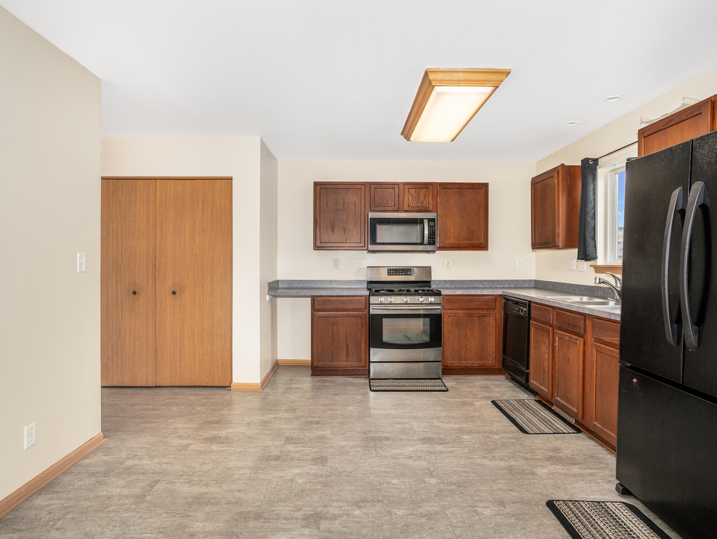 816 Kennedy Street Waterman, IL 60556 - Photo 9 of 27 a kitchen with stainless steel appliances a refrigerator stove and microwave