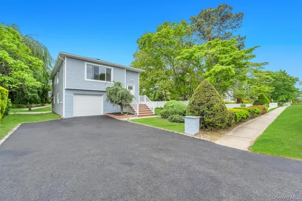 a view of a house with a yard and garage