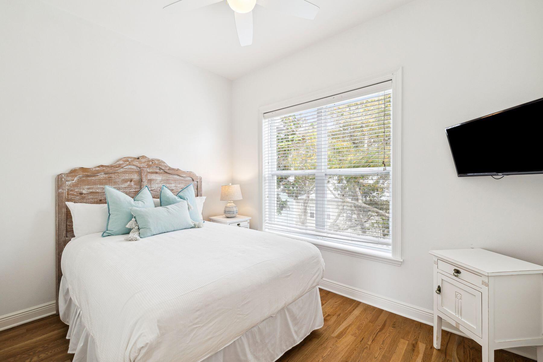 32 Hickory Street Santa Rosa Beach, FL 32459 - Photo 20 of 33 a bedroom with a bed and a flat tv screen on the dresser