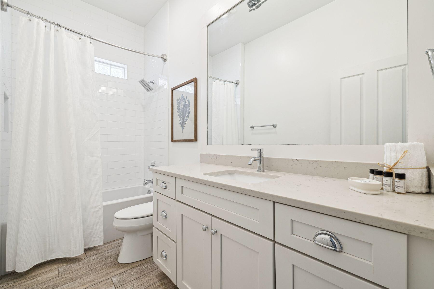 32 Hickory Street Santa Rosa Beach, FL 32459 - Photo 22 of 33 a bathroom with a granite countertop sink a toilet and a shower
