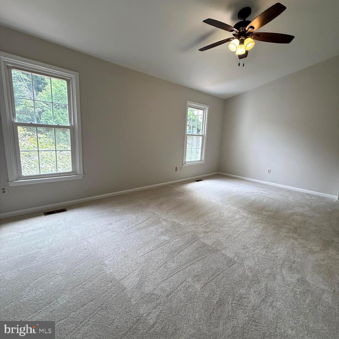 8442 Springfield Oaks Drive Springfield, VA 22153 - Photo 11 of 31 an empty room with windows and fan chandelier fan