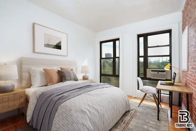 a bedroom with a bed and large windows