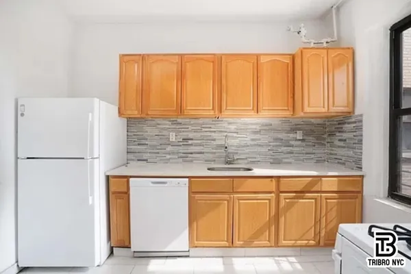 a white refrigerator freezer sitting inside of a kitchen