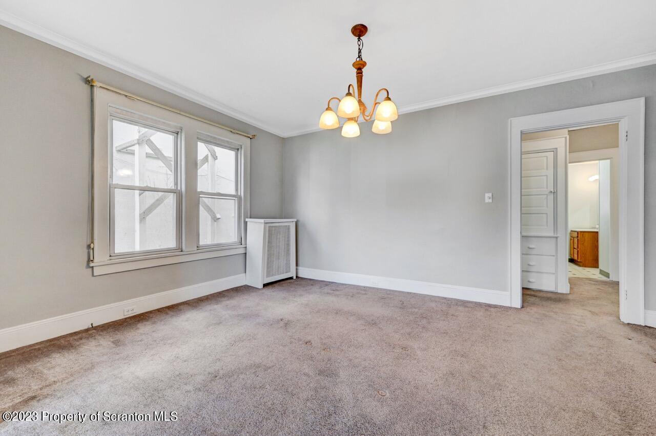 538 Wheeler Avenue Scranton, PA 18510 - Photo 11 of 65 an empty room with chandelier fan and windows