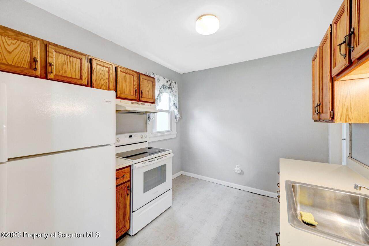 538 Wheeler Avenue Scranton, PA 18510 - Photo 21 of 65 a kitchen with a refrigerator and a stove