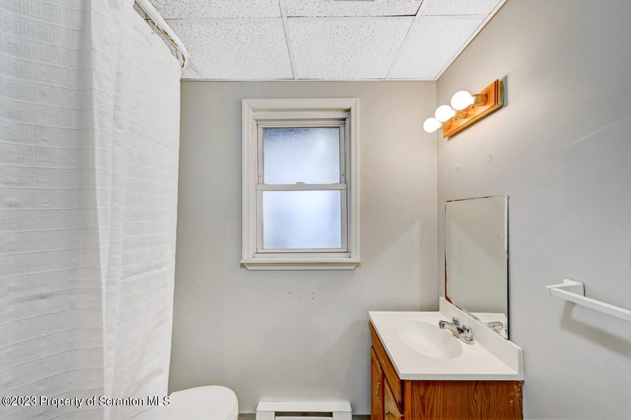 538 Wheeler Avenue Scranton, PA 18510 - Photo 24 of 65 a bathroom with a sink a toilet and mirror