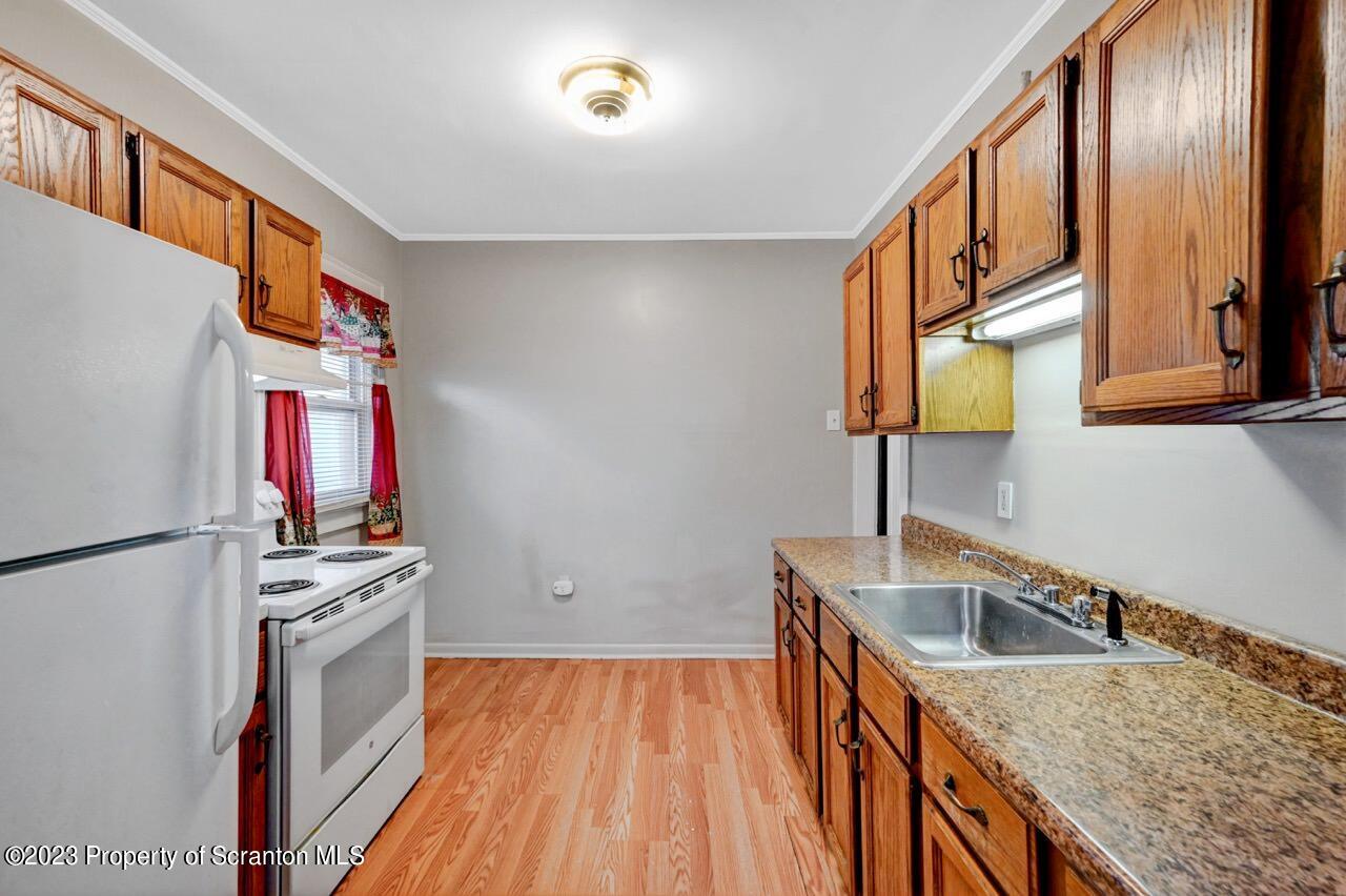 538 Wheeler Avenue Scranton, PA 18510 - Photo 45 of 65 a kitchen that has a sink a stove and a wooden floor