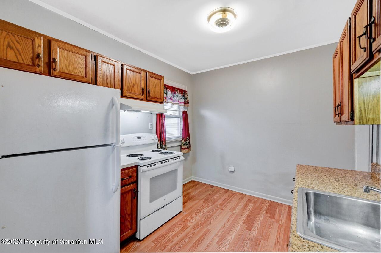 538 Wheeler Avenue Scranton, PA 18510 - Photo 46 of 65 a kitchen with stainless steel appliances granite countertop a refrigerator a stove a sink and a microwave