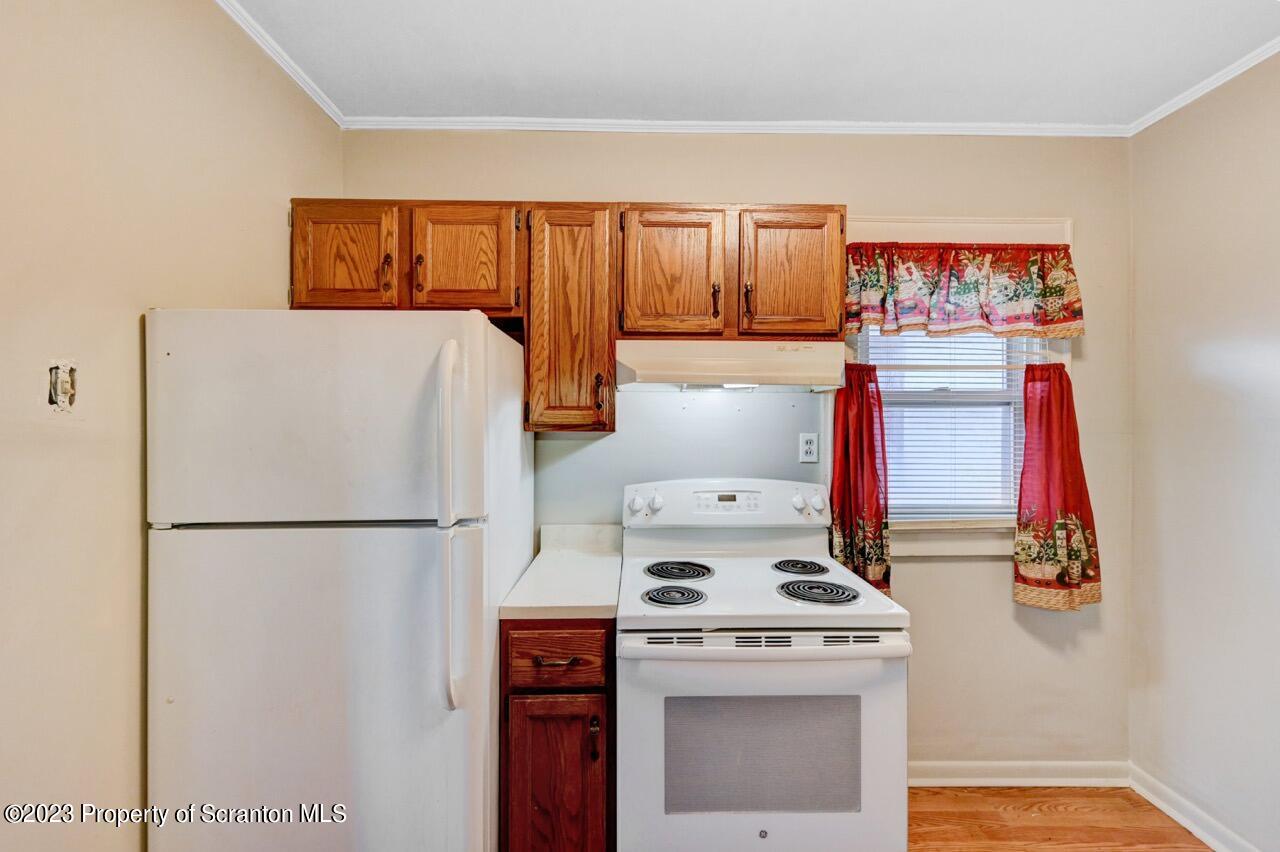 538 Wheeler Avenue Scranton, PA 18510 - Photo 48 of 65 a white refrigerator freezer and a stove sitting inside of a kitchen
