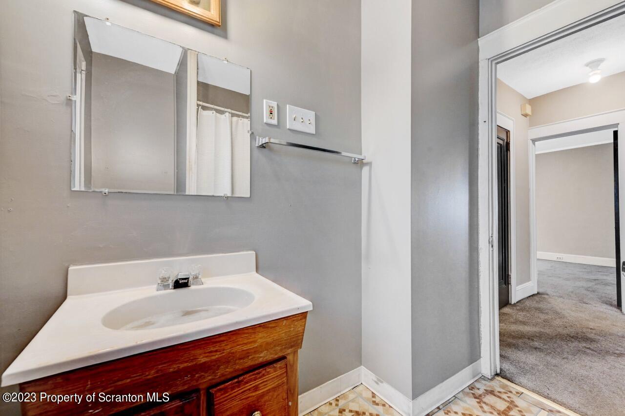 538 Wheeler Avenue Scranton, PA 18510 - Photo 54 of 65 a bathroom with a sink a toilet and mirror