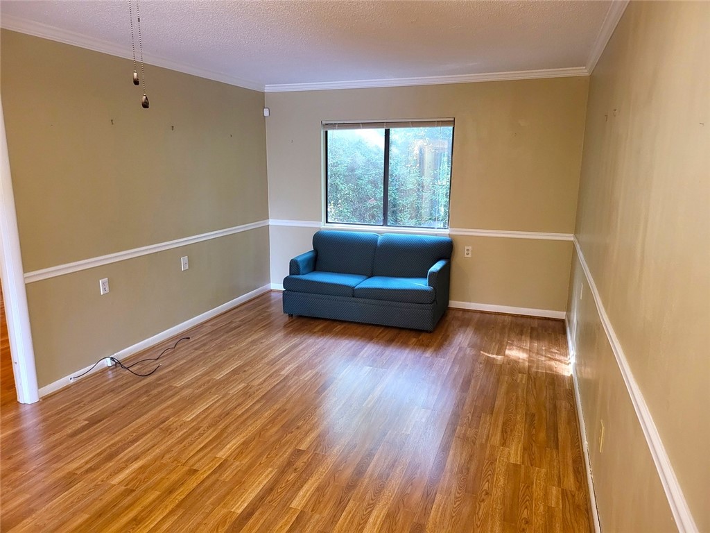 150 Ligon Street, Unit 1001 Clemson, SC 29631 - Photo 4 of 29 Well-lit living area features warm wood flooring and elegant crown molding.