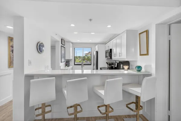 a kitchen with a table and chairs in it