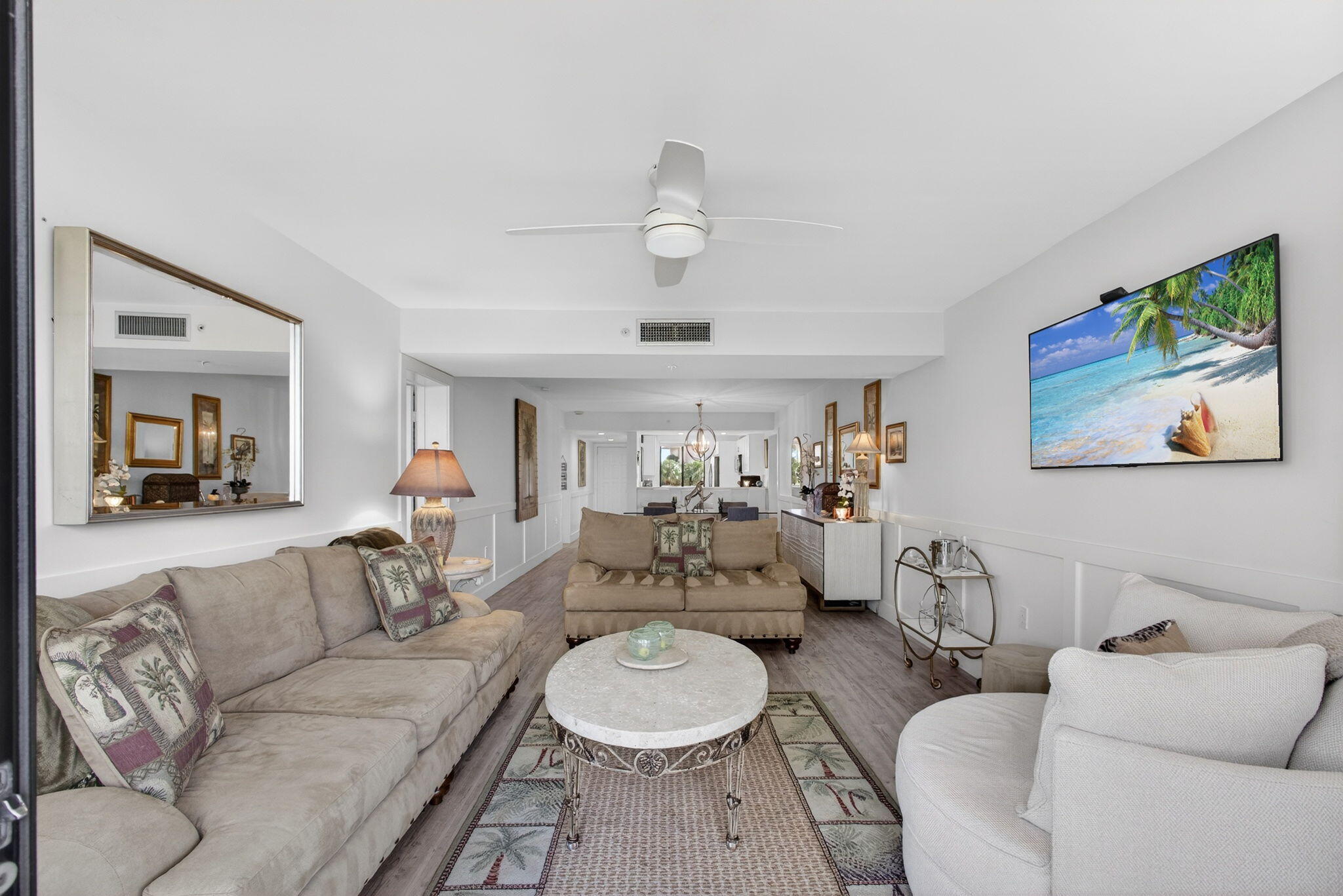 1901 Marina Isle Way, Unit 304 Jupiter, FL 33477 - Photo 14 of 64 a living room with furniture a rug and a chandelier