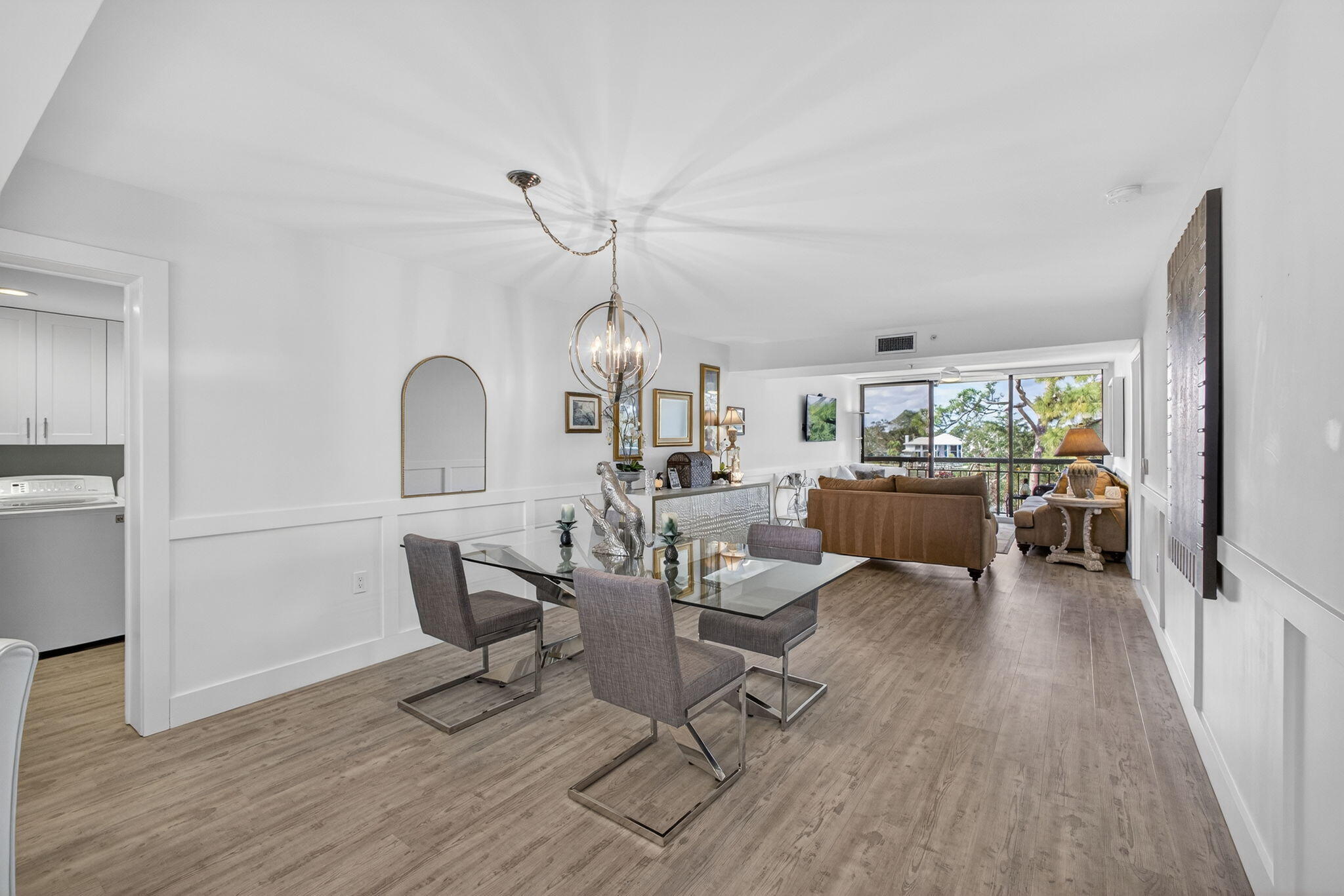 1901 Marina Isle Way, Unit 304 Jupiter, FL 33477 - Photo 15 of 64 a living room with couches a dining table and chairs with wooden floor