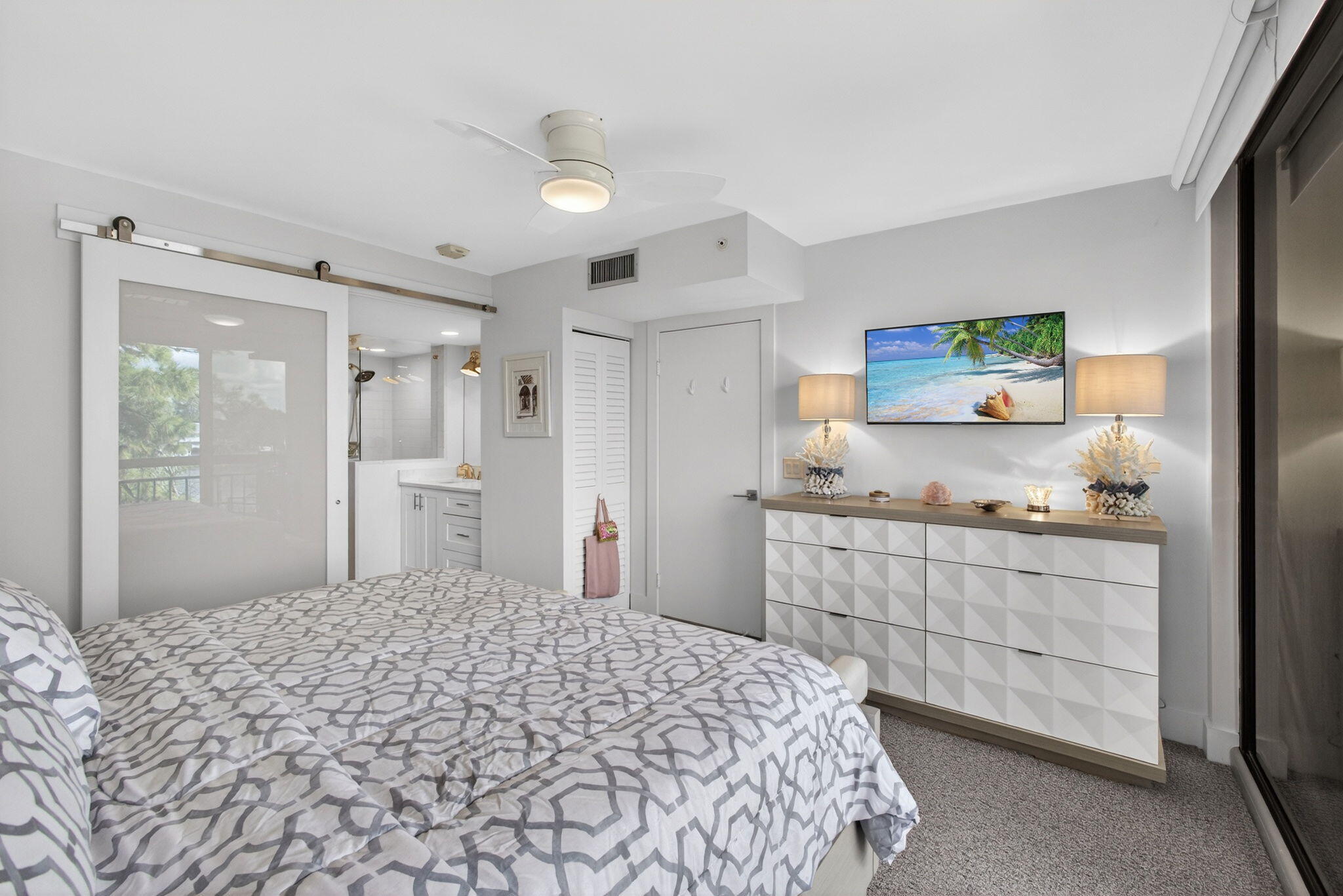 1901 Marina Isle Way, Unit 304 Jupiter, FL 33477 - Photo 21 of 64 a bedroom with a bed and a cabinets