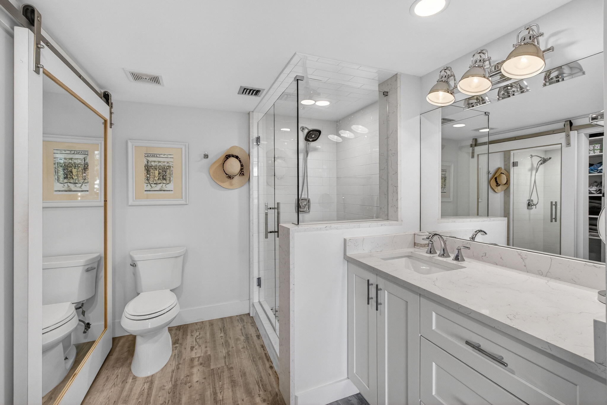1901 Marina Isle Way, Unit 304 Jupiter, FL 33477 - Photo 22 of 64 a bathroom with a sink a toilet and a large mirror