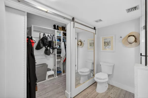 a bathroom with a granite countertop sink a toilet and shower