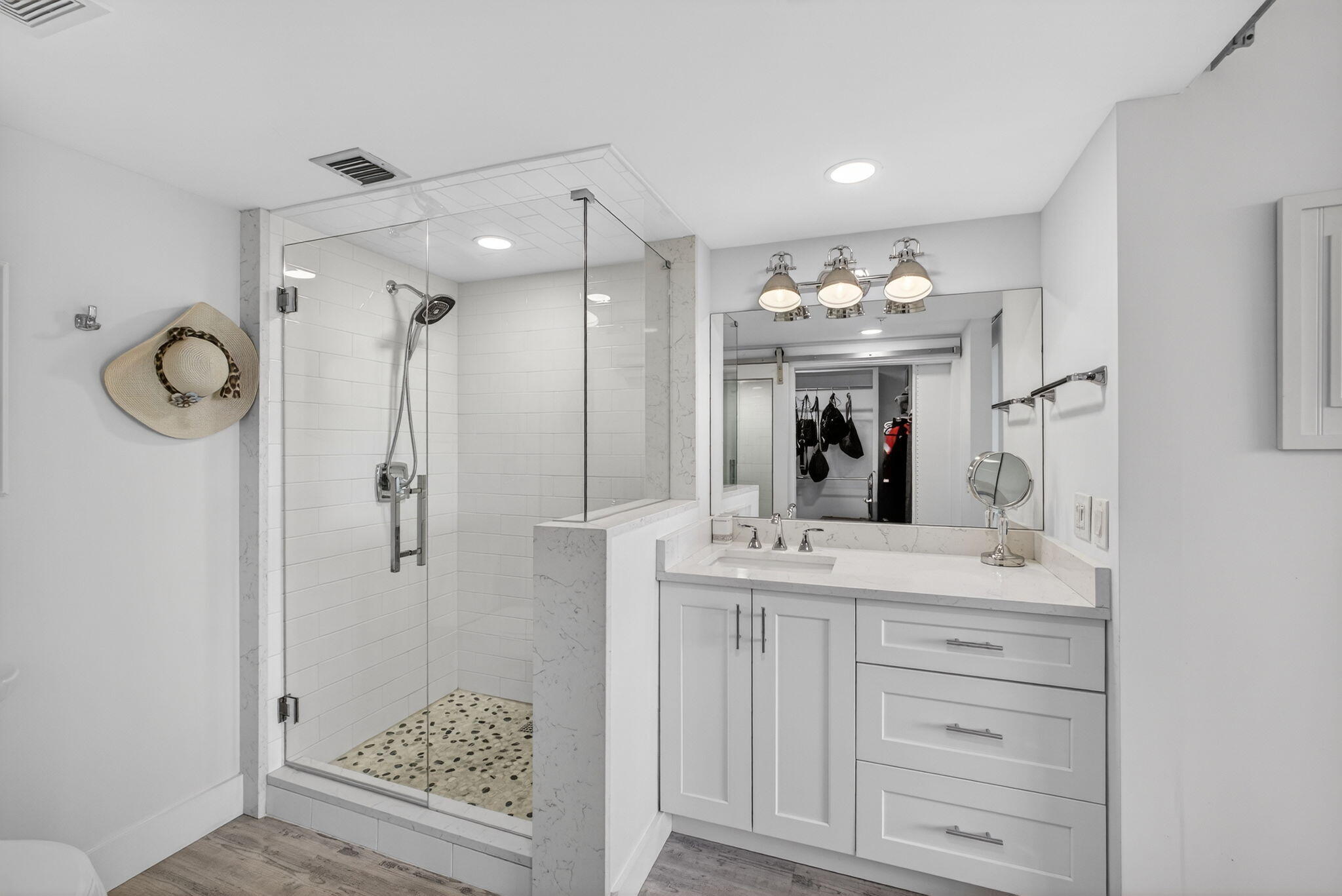 1901 Marina Isle Way, Unit 304 Jupiter, FL 33477 - Photo 24 of 64 a bathroom with a sink a vanity a large mirror and shower