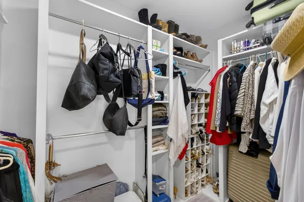 a spacious bathroom with a double vanity sink a large mirror and a toilet