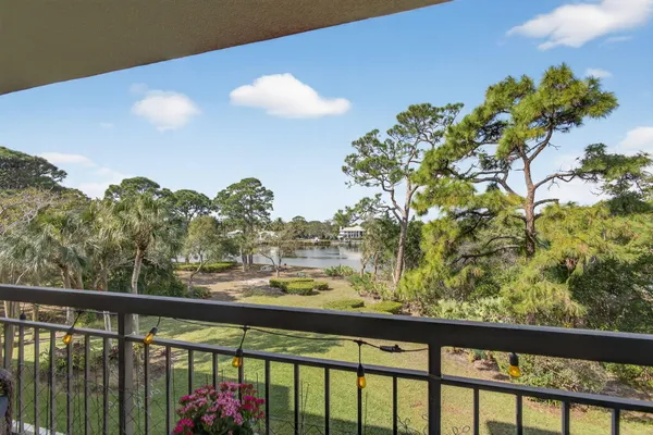 a view of a balcony next to a yard