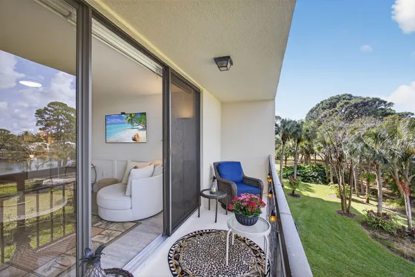 a view of a building with a garden and pathway