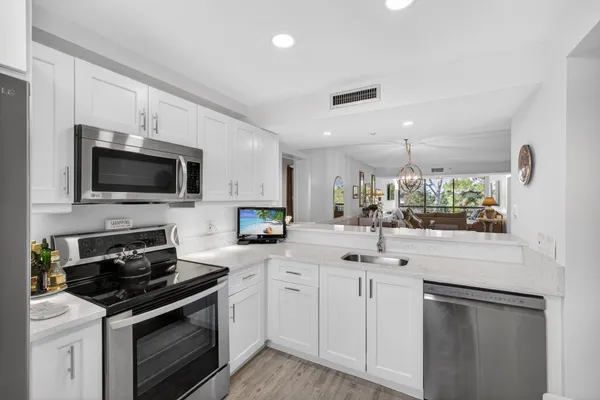 a kitchen with stainless steel appliances a refrigerator and a stove