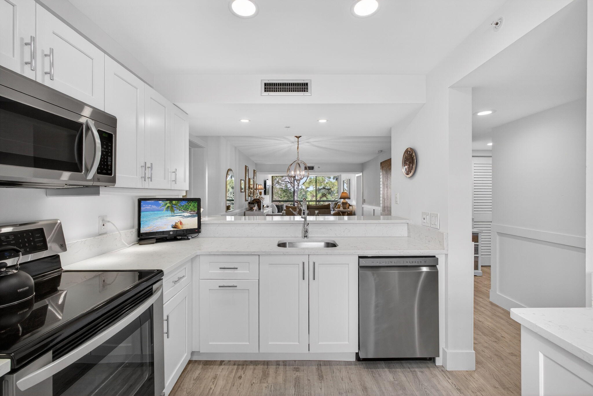 1901 Marina Isle Way, Unit 304 Jupiter, FL 33477 - Photo 8 of 64 a kitchen with stainless steel appliances a sink stove and microwave