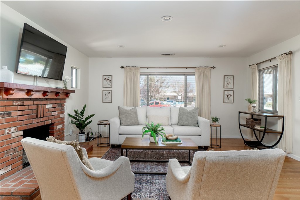 8650 Santa Rosa Road Atascadero, CA 93422 - Photo 1 of 1 a living room with furniture a flat screen tv and a fireplace