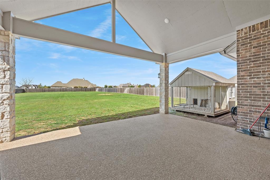 23 Independence Trail Waco, TX 76708 - Photo 28 of 35 Covered outdoor patio with a textured concrete surface and stone-clad support pillars