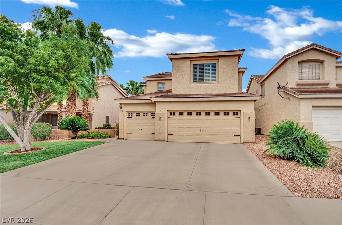 1724 Millstream Way Henderson, NV 89074 - Photo 5 of 60 A desert oasis with dual garage access and mature palms, offering shaded charm.