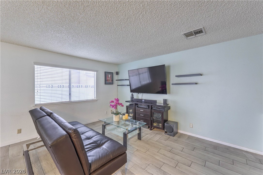 581 Carleton Drive Henderson, NV 89014 - Photo 6 of 37 A well-lit living area with clean, simple lines and inviting flooring.