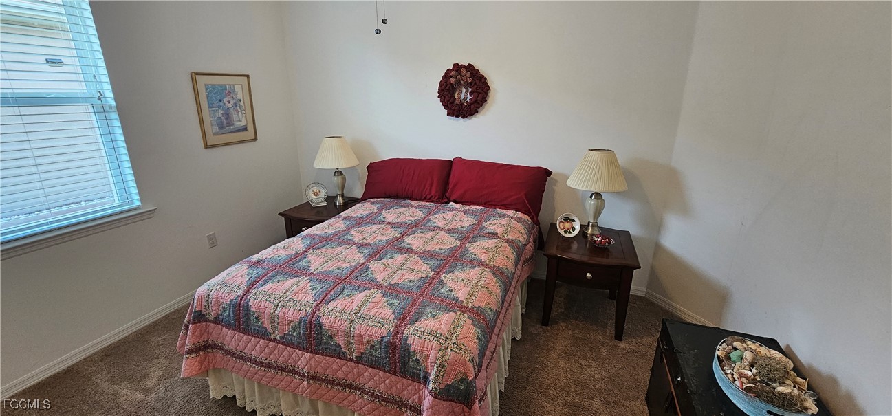 10788 Crossback Lane Lehigh Acres, FL 33936 - Photo 12 of 32 a bedroom with a bed and a chair