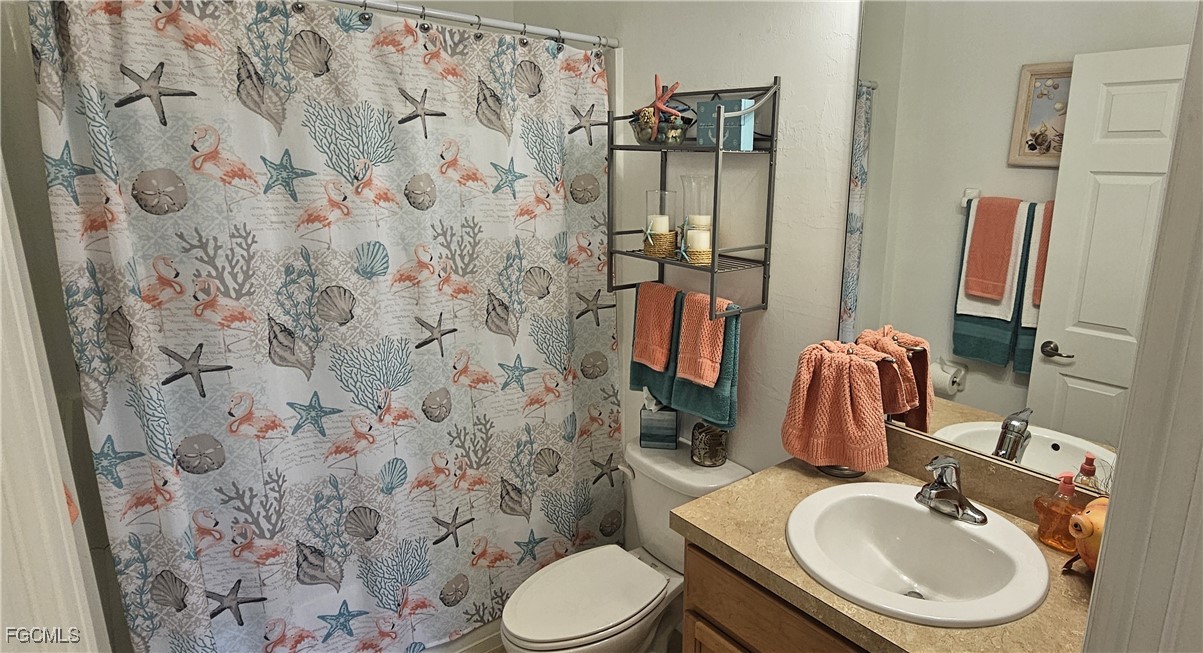 10788 Crossback Lane Lehigh Acres, FL 33936 - Photo 13 of 32 a bathroom with a sink toilet and shower