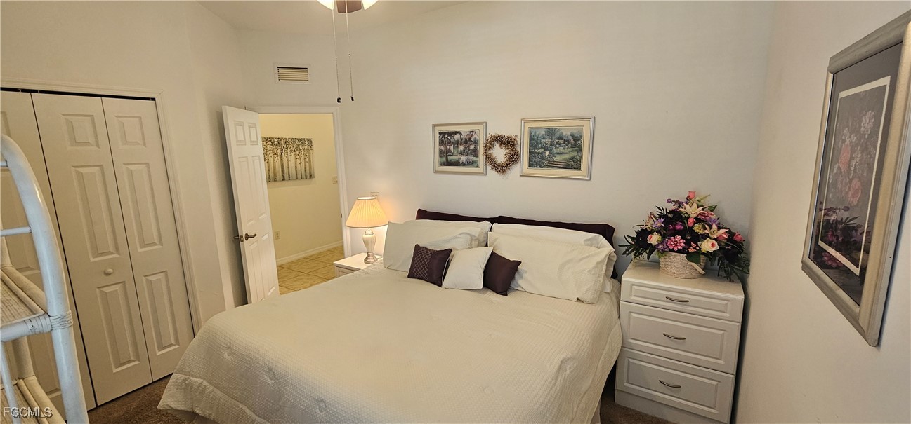 10788 Crossback Lane Lehigh Acres, FL 33936 - Photo 14 of 32 a bedroom with a bed and a closet