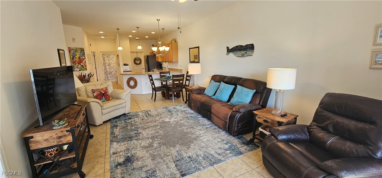 10788 Crossback Lane Lehigh Acres, FL 33936 - Photo 18 of 32 a living room with furniture and a flat screen tv
