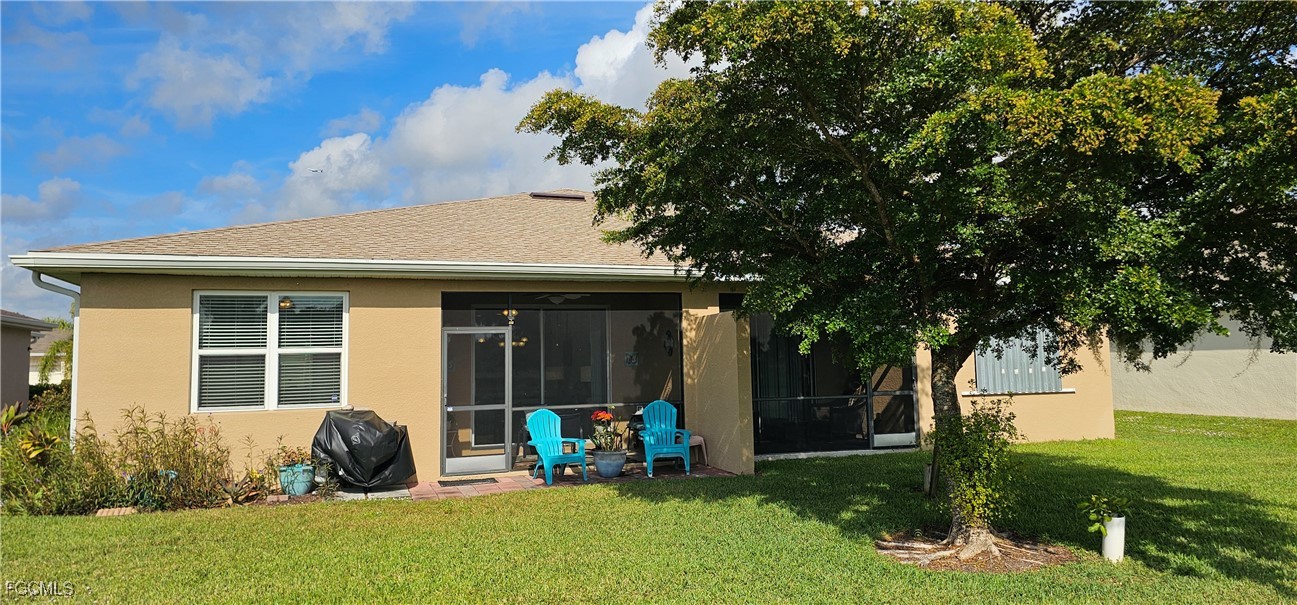 10788 Crossback Lane Lehigh Acres, FL 33936 - Photo 2 of 32 a backyard of a house with seating space