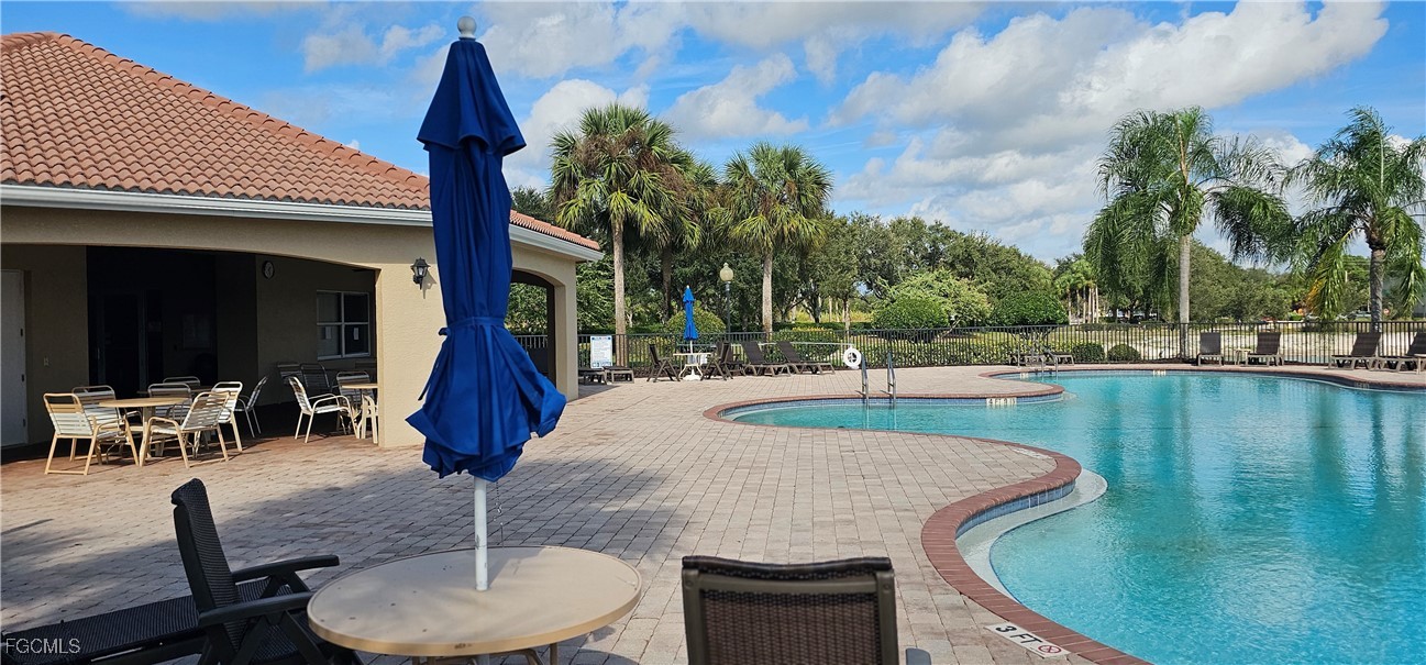 10788 Crossback Lane Lehigh Acres, FL 33936 - Photo 22 of 32 a view of a swimming pool with outdoor seating