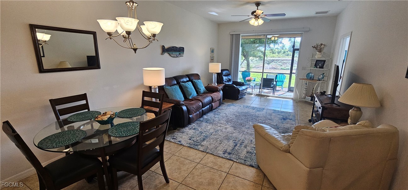 10788 Crossback Lane Lehigh Acres, FL 33936 - Photo 28 of 32 a living room with furniture chandelier and a fireplace