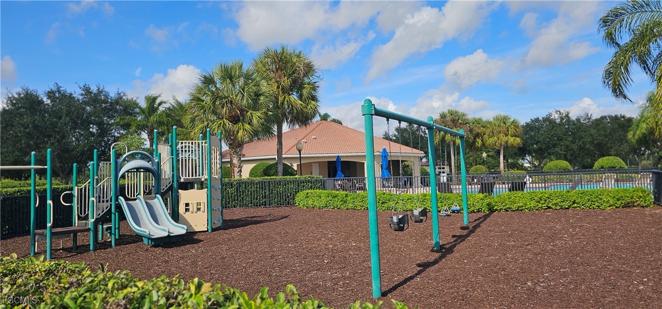 10788 Crossback Lane Lehigh Acres, FL 33936 - Photo 30 of 32 a view of a house with a yard and potted plants