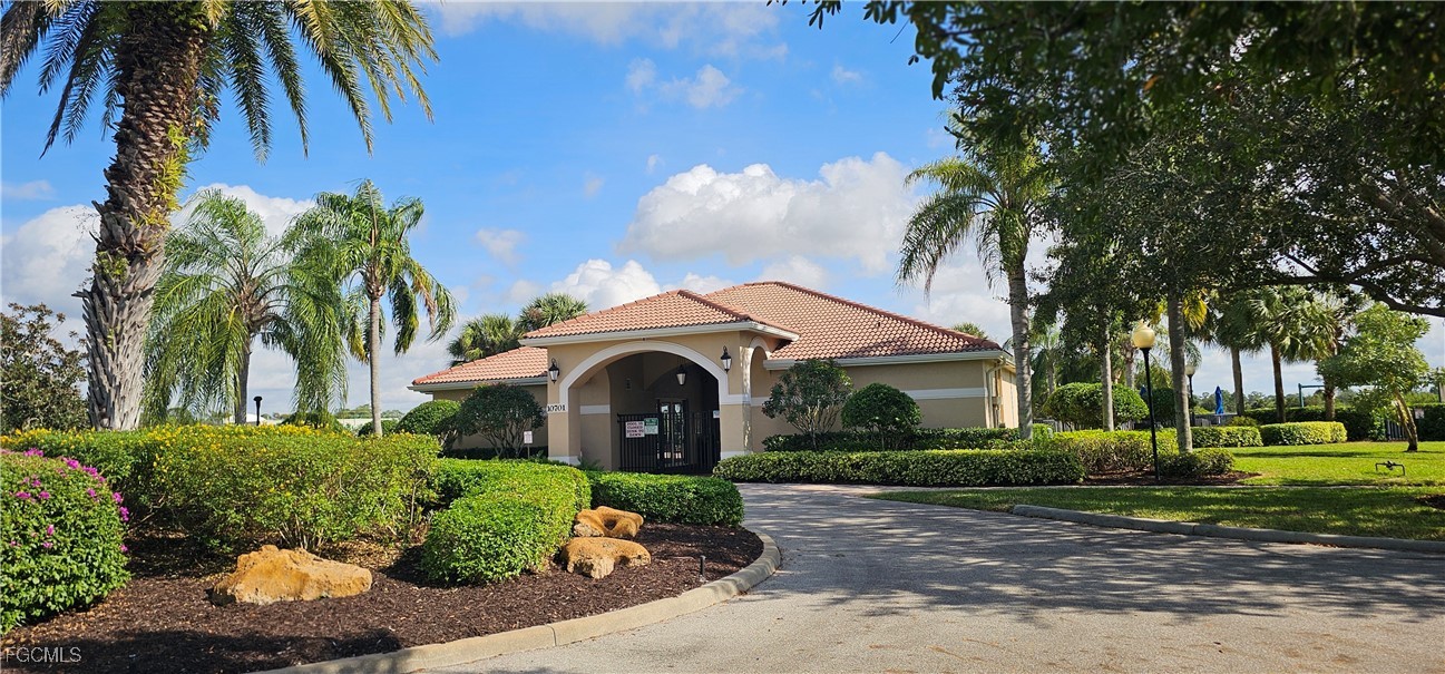 10788 Crossback Lane Lehigh Acres, FL 33936 - Photo 7 of 32 a front view of a house with a yard