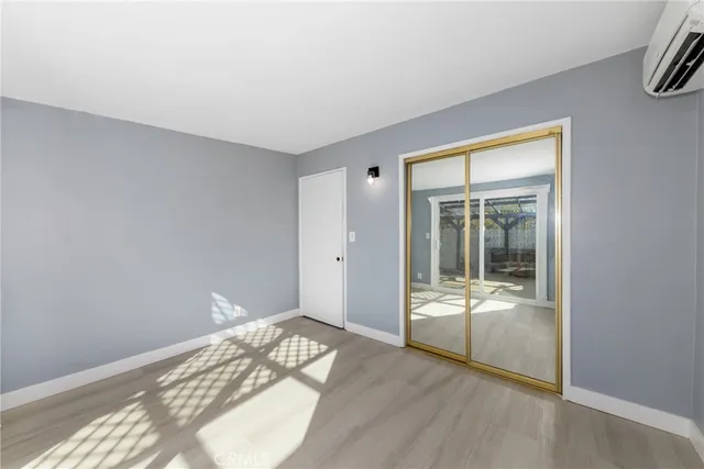 a view of a room with wooden floor and windows