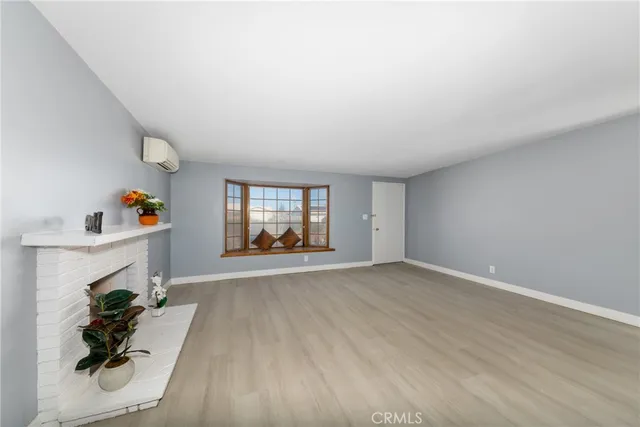 an empty room with furniture and a fireplace