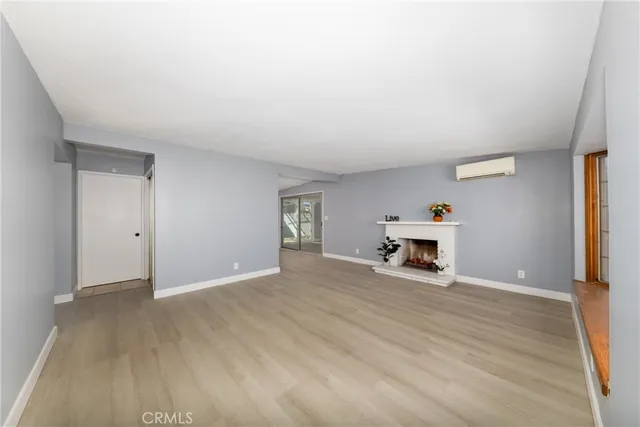 a view of a livingroom with a fireplace and a window