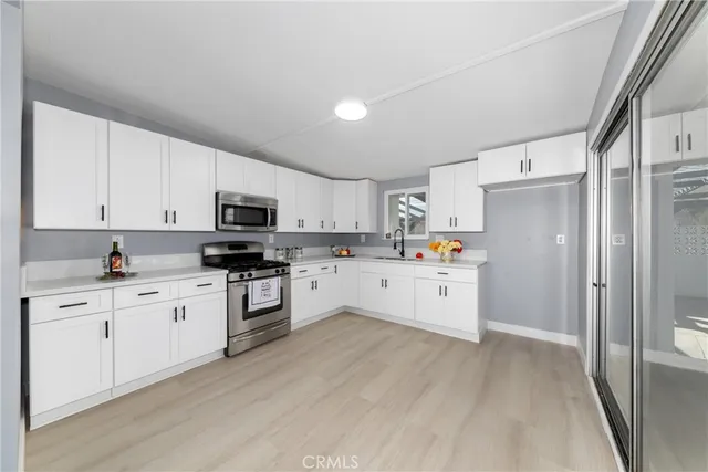a kitchen with white cabinets and white appliances