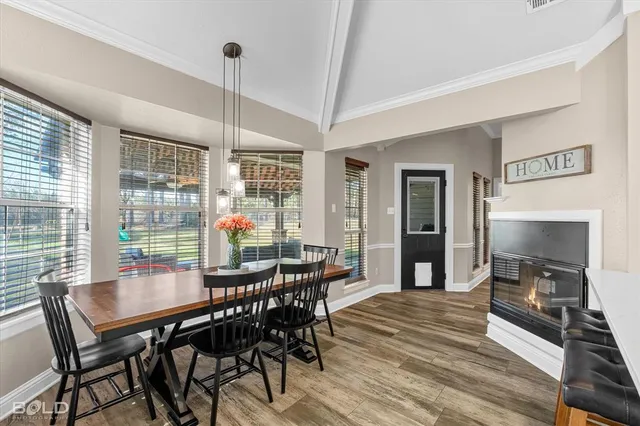 a dining room with furniture window and wooden floor
