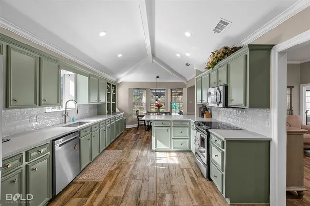 a kitchen with sink stove and cabinets