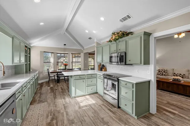 a kitchen with sink stove and refrigerator