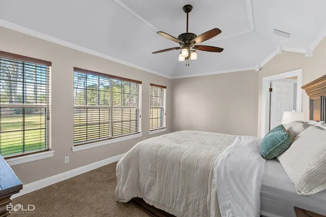 a bedroom with a large bed and a window